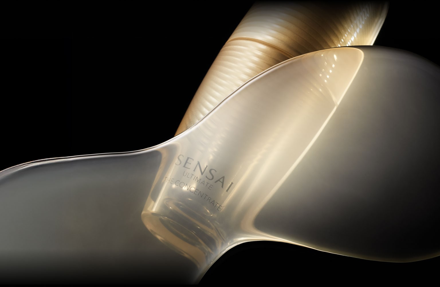 Shiny golden bottle illuminated by golden light against black background.