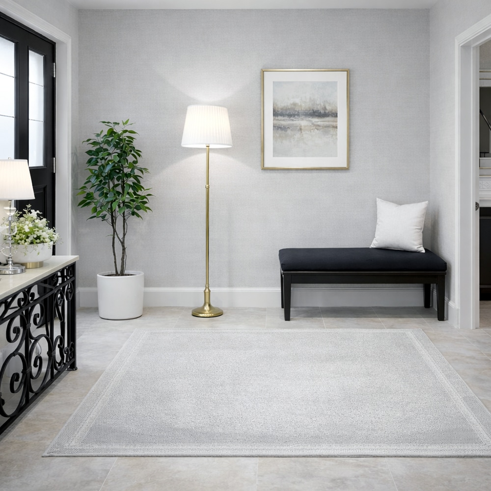 コンソールテーブルの向かい側にラグと照明を配置して整えた玄関インテリア