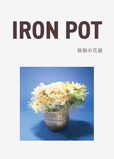 金の鉄製花器に黄色のフラワーアレンジメント