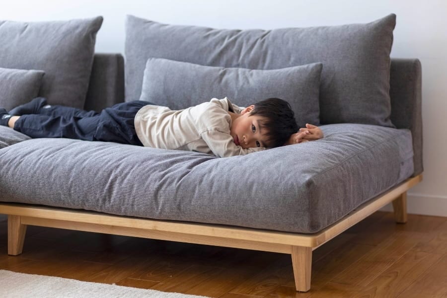 幸せになるソファでゴロゴロ寝転がる子ども