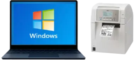 Windowsのロゴを表示したノートパソコンと、並んで置かれた据置型ラベルプリンター