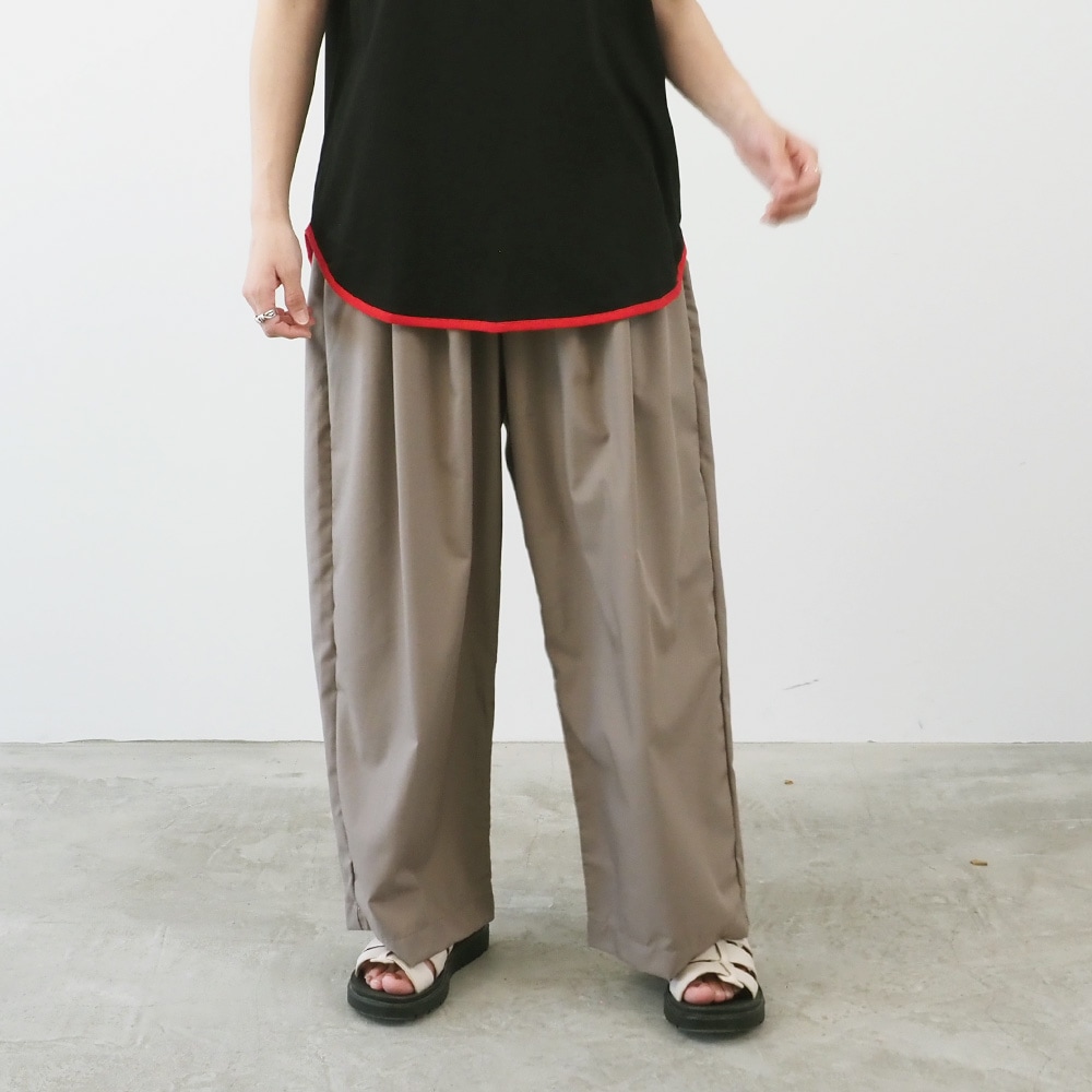 トロンとツイル タックワイドパンツを穿いた女性　ワイドタックパンツを穿いた女性の全身