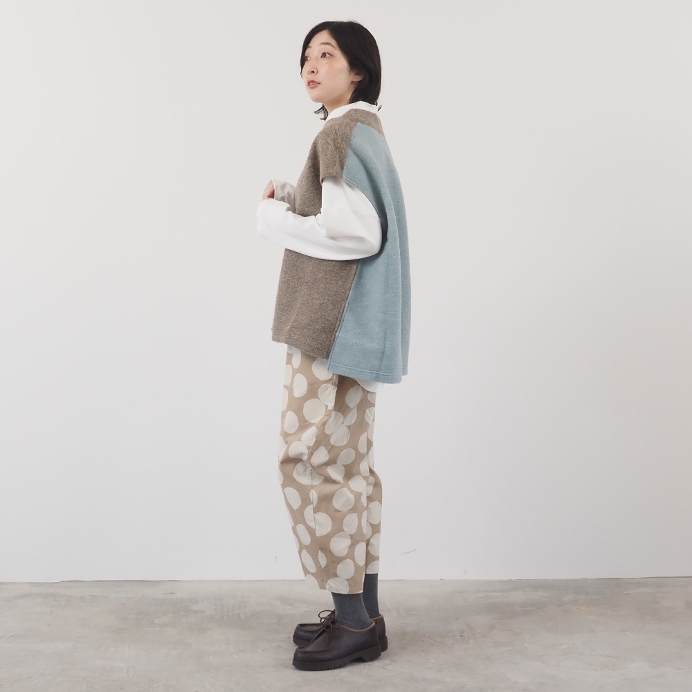 トラベルウールプレミア バイカラーベスト　ベストを着た女性の全身