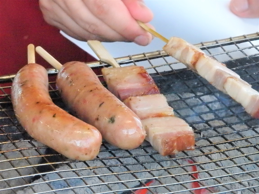 美味しそうに焼けているトンデンファーム製のソーセージとベーコン